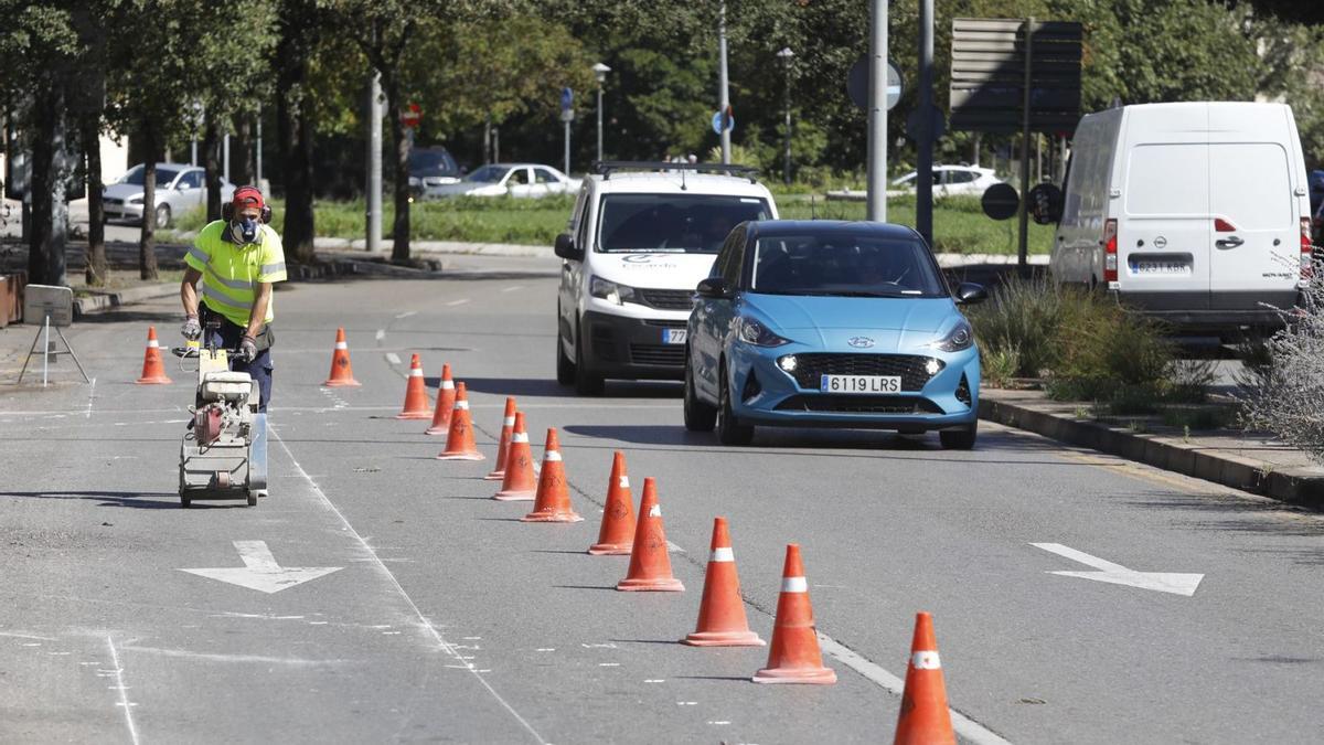 Un operari de les brigades municipals, ahir al matí, marcant el nou carril bici. | ANIOL RESCLOSA