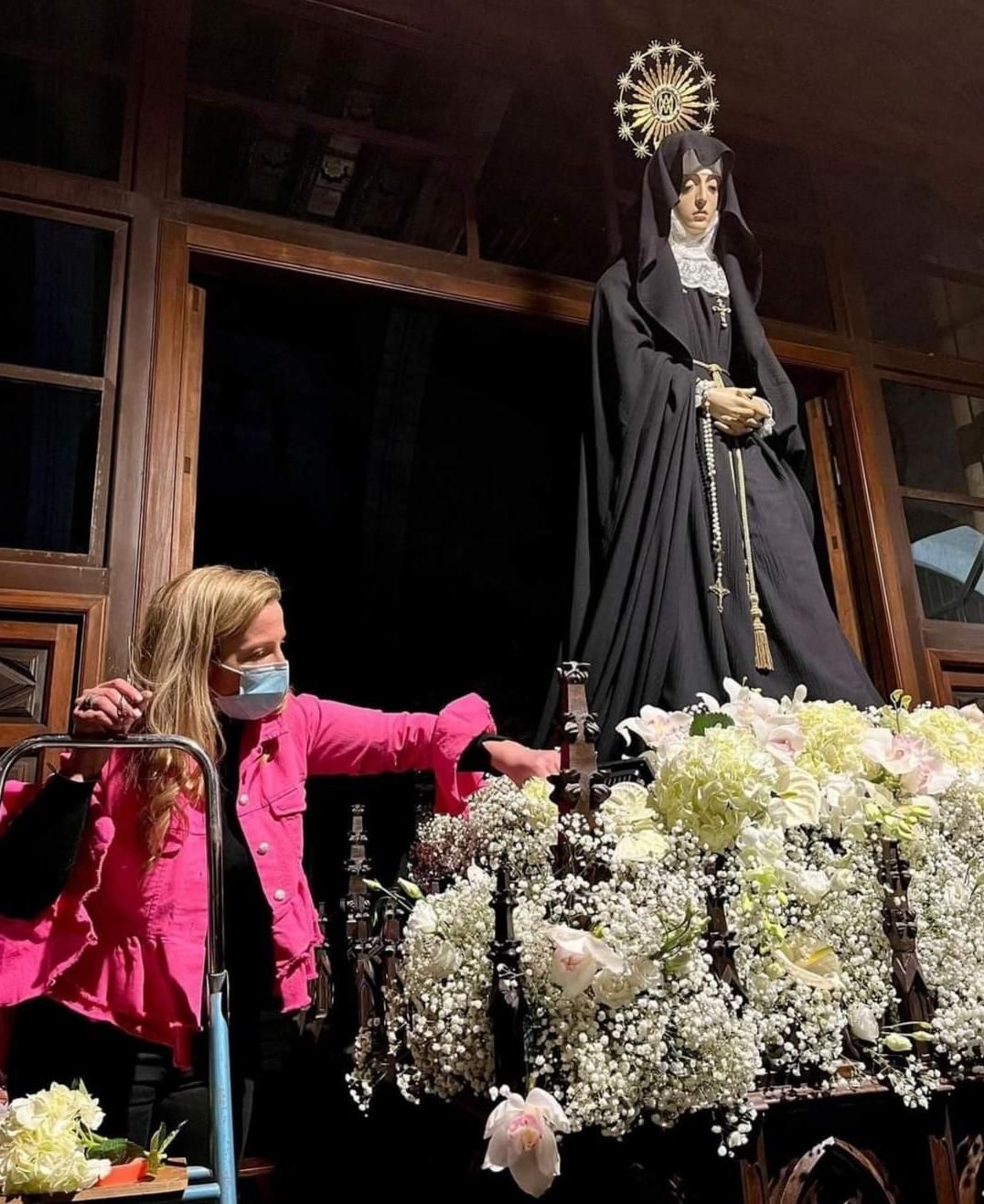Marta Alonso prepara el adorno floral de la mesa de la imagen de Ramón Álvarez en San Juan. 