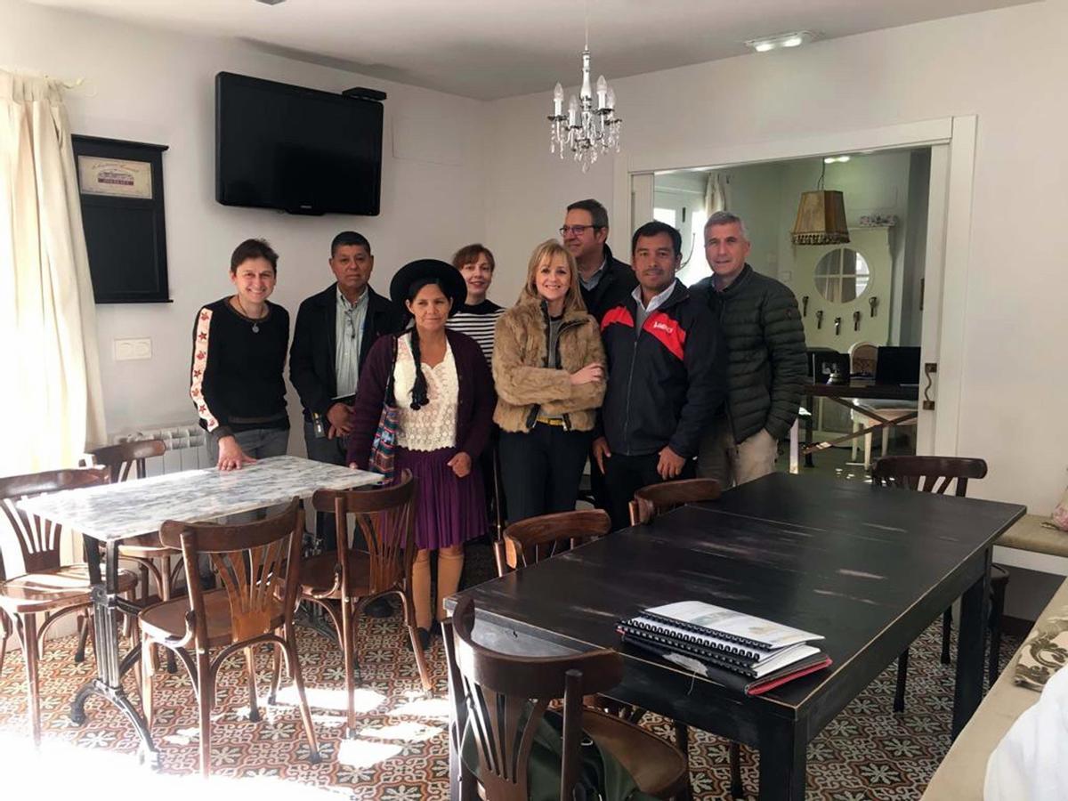Laura Fernández (con camiseta de rayas), junto a autoridades de Sobrescobio y del plan “Leader” y miembros de una delegación boliviana que visitó Redes para conocer proyectos de emprendedores rurales, en el hotel El Secreto de Julia