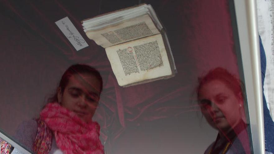 Dos jóvenes observan uno de los códices de los manuscritos lulianos.
