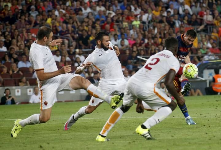 Barcelona's Lionel Messi shoots to score a goal against AS Roma during a friendly match at Camp Nou stadium in Barcelona,