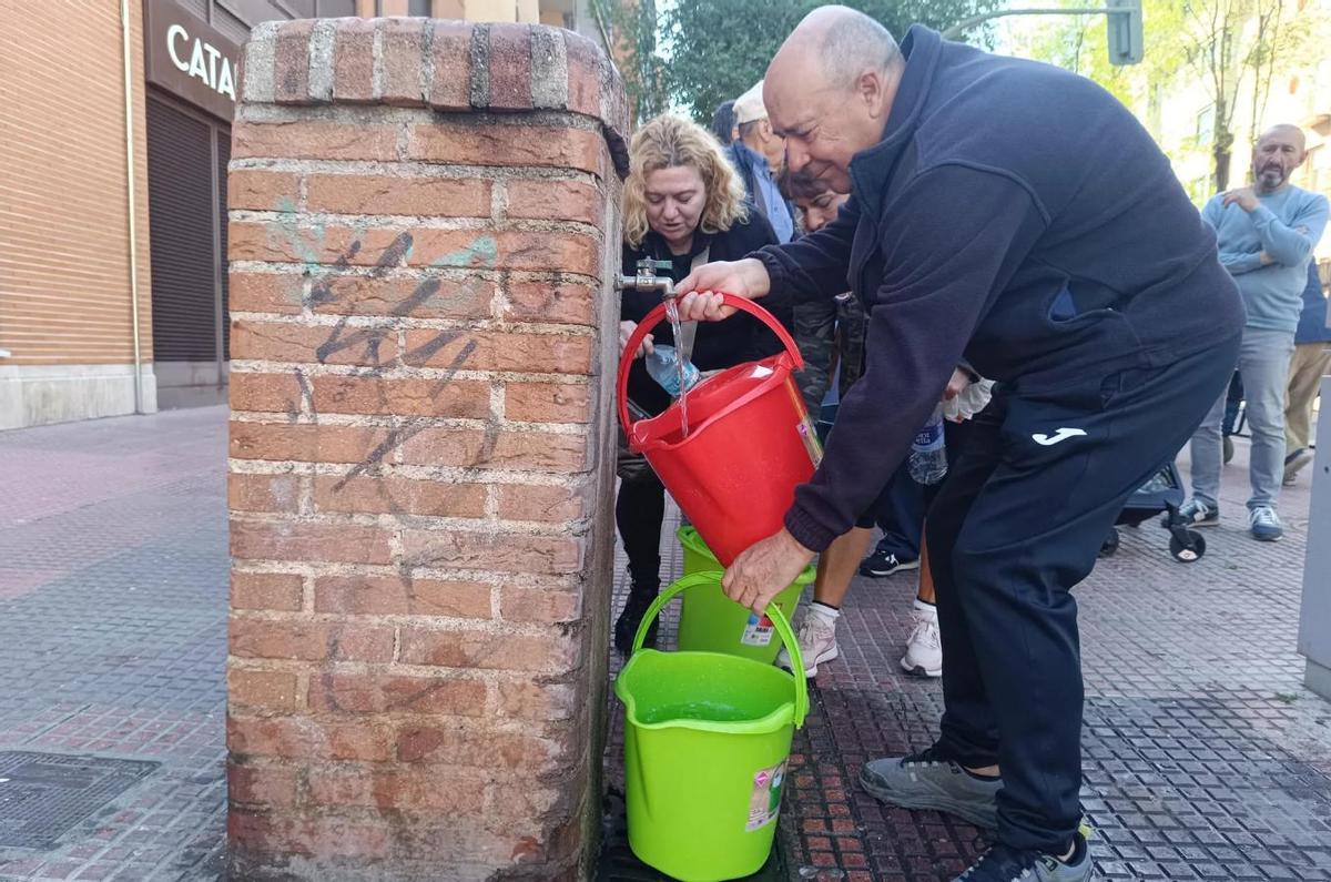 Varias personas toman agua de una fuente este miércoles en Alcalá de Henares