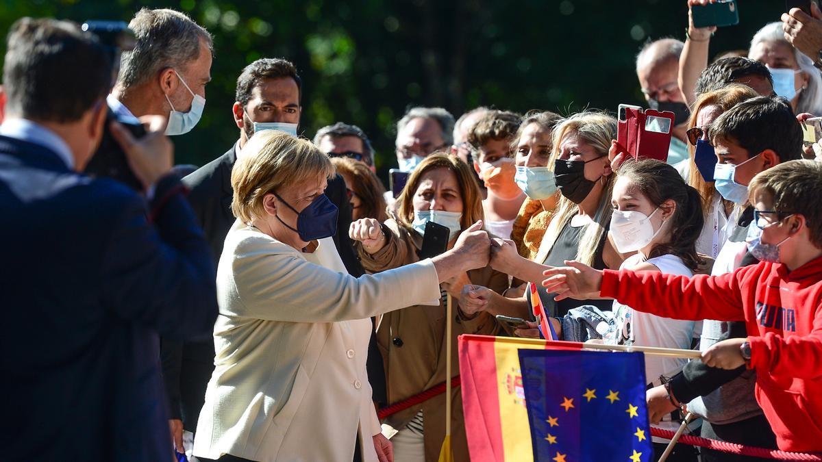 Angela Merkel, saludando a los niños de un colegio.