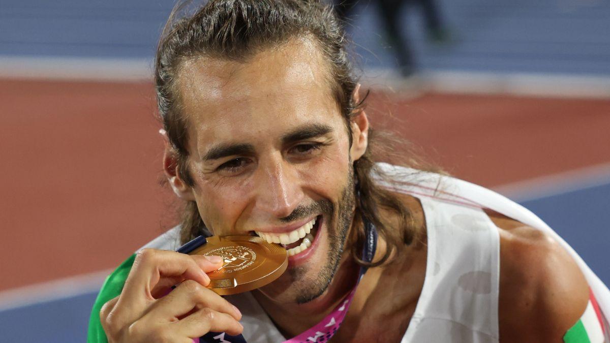 Un radiante Tamberi muerde su medalla de oro.