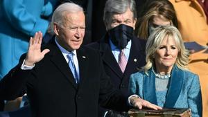 Joe Biden  flanked by incoming US First Lady Jill Biden takes the oath of office as the 46th US President by Supreme Court Chief Justice John Roberts during the swearing-in ceremony of the 46th US President on January 20  2021  at the US Capitol in Washington  DC  (Photo by Brendan SMIALOWSKI   POOL   AFP)