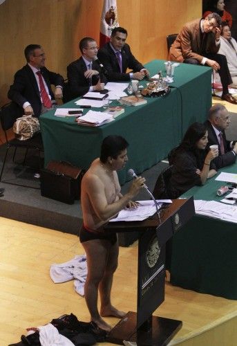 Antonio Garcia of the PRD addresses the audience after stripping down to his underwear during his speech in Mexico City
