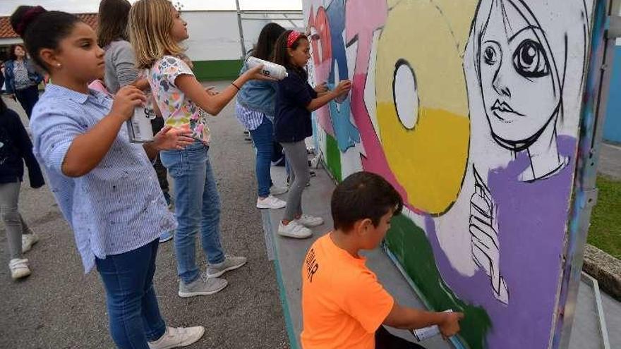 Jóvenes pintando un grafiti en el DepoRÚArte. // G.S.