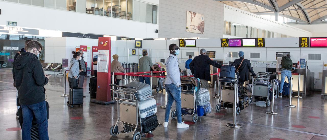 Pasajeros facturando equipajes en  la terminal del aeropuerto