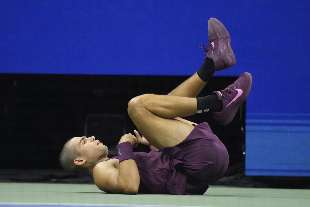 Carlos Alcaraz, of Spain, falls to the court against Reilly Opelka, of the United States, during the first round of the U.S. Open tennis championships, Monday, Aug. 25, 2025, in New York. (AP Photo/Frank Franklin II)