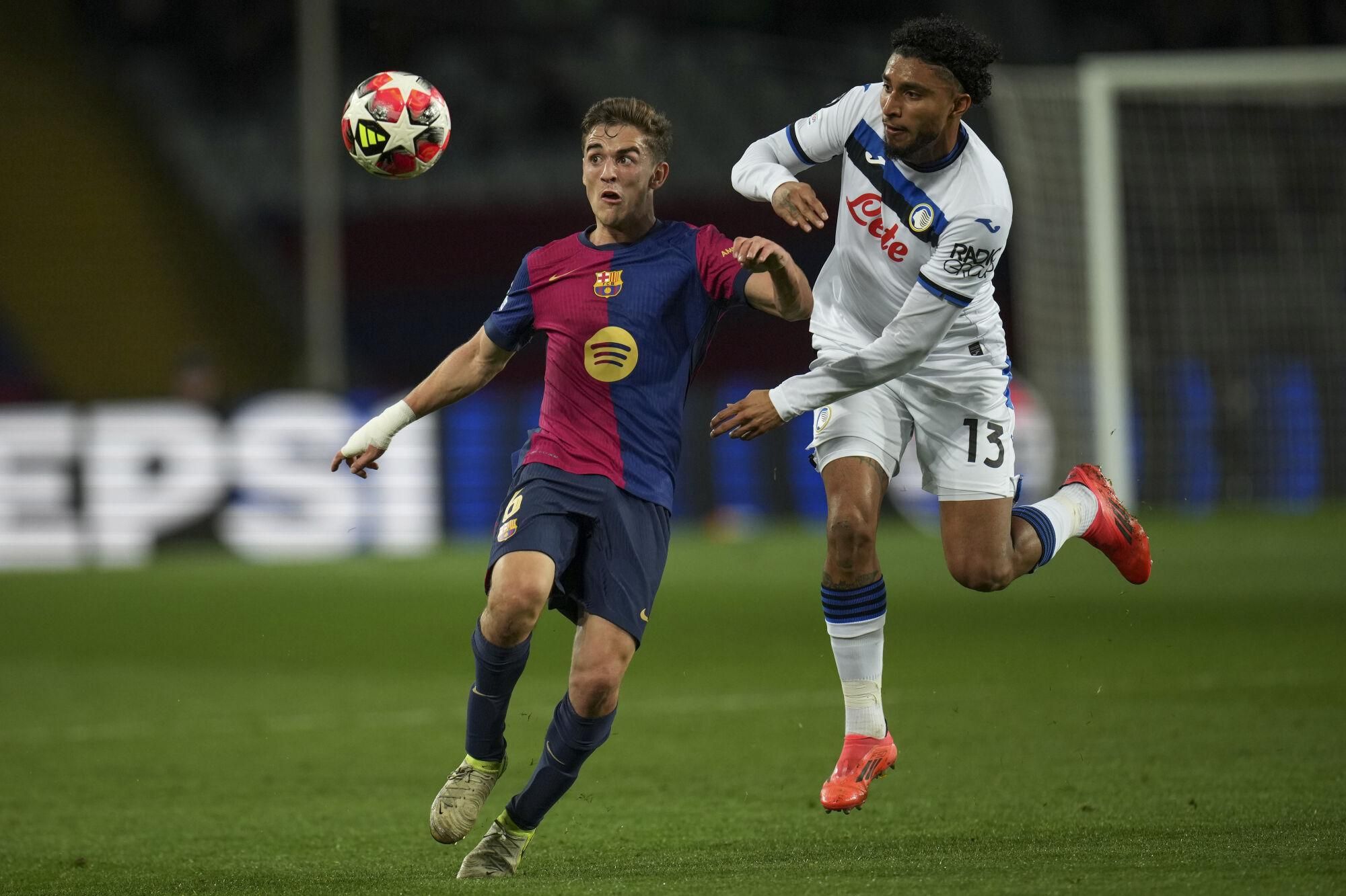 Barcelona's Gavi, left, vies for the ball with Atalanta's Ederson during a Champions League opening phase soccer between Barcelona and Atalanta match at the Lluis Companys Olympic stadium in Barcelona, Spain, Wednesday, Jan. 29, 2025. (AP Photo/Emilio Morenatti)