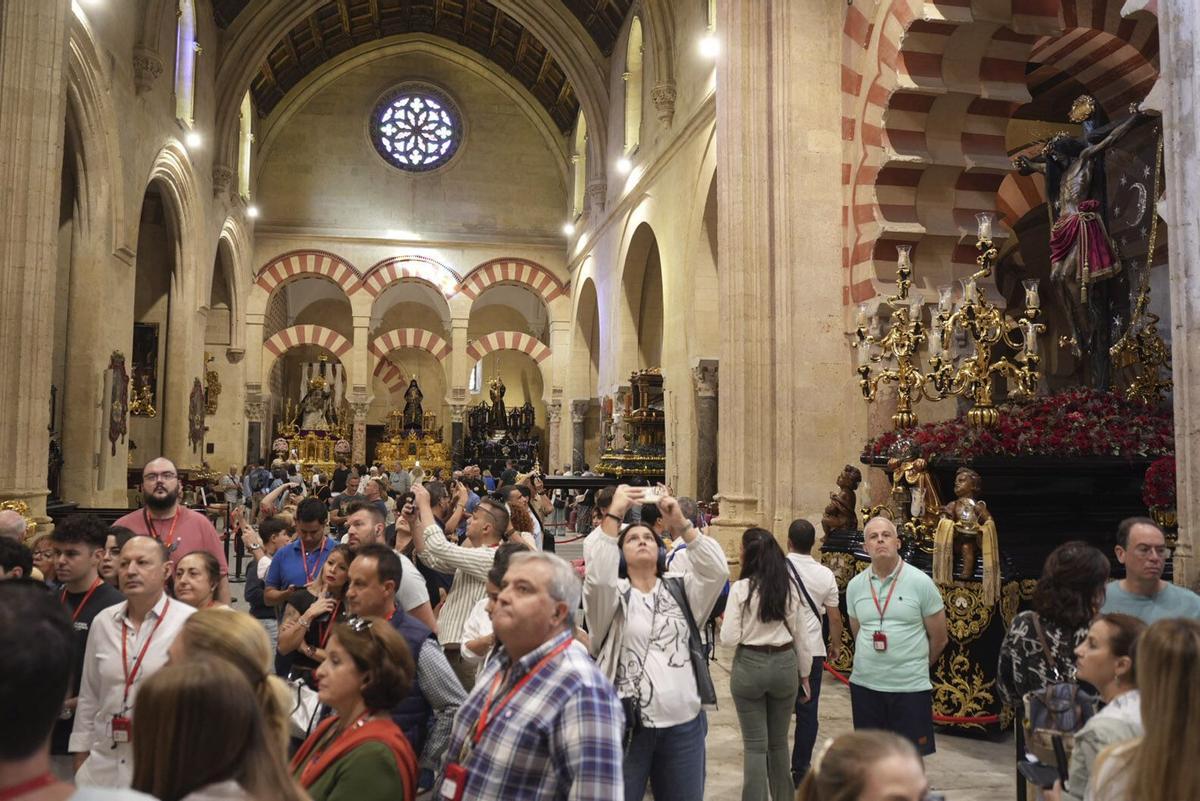 Turistas durante la exposición de las imágenes del Magno Vía Crucis en la Mezquita Catedral de Córdoba.