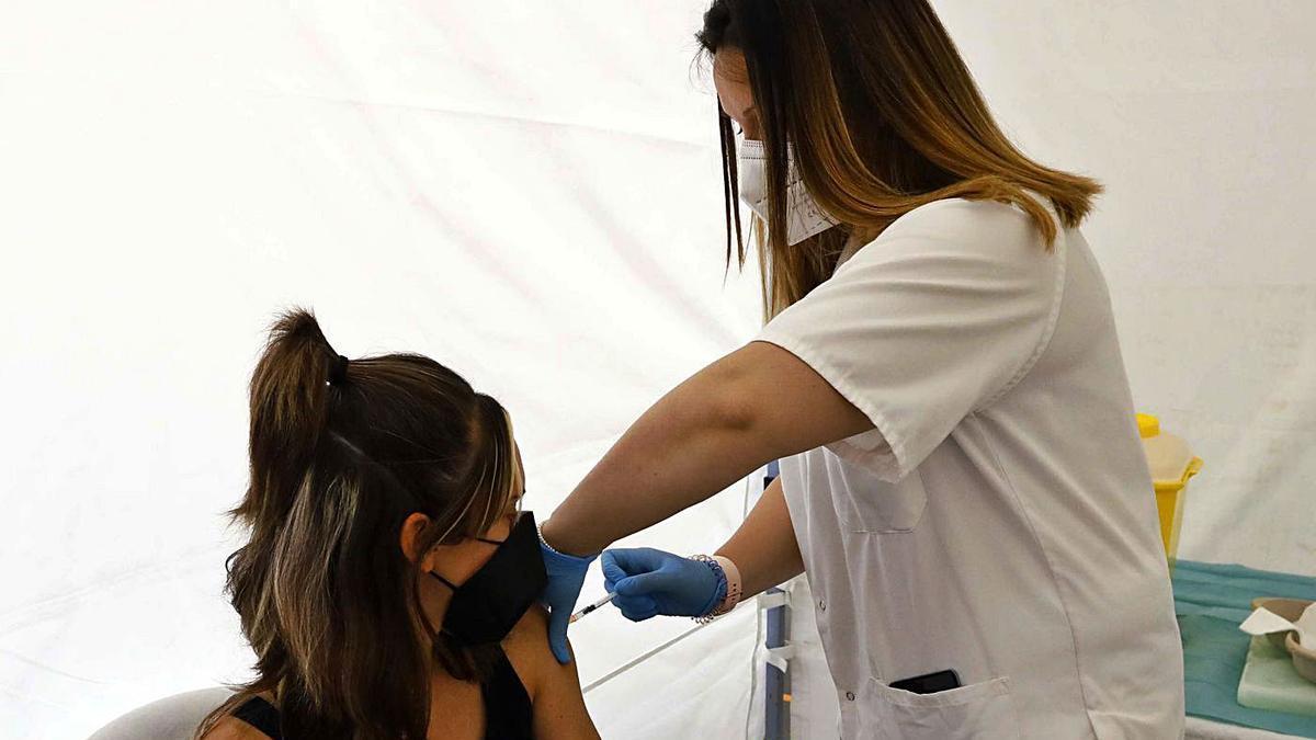 Una enfermera vacuna a una joven, el pasado junio, en el pabellón polideportivo de la Universidad de Zaragoza.