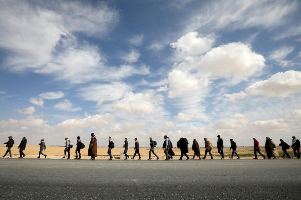 People walk during a march from the city of ...