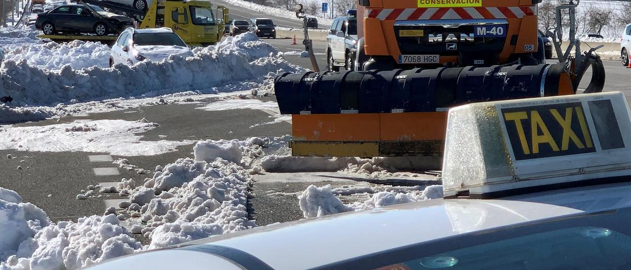 A taxi is towed on M-40 highway after heavy snowfall in Madrid