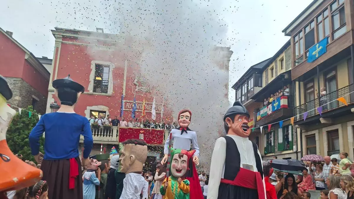 La lluvia no frena la fiesta en Navia: los vecinos arropan a los gigantes y los cabezudos en el chupinazo de La Barca y San Roque