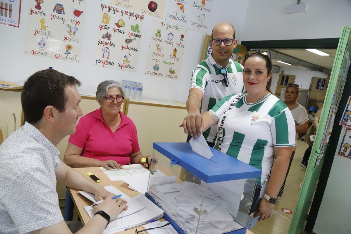 Una pareja de cordobesistas vota antes de acudir a animar al Córdoba CF.