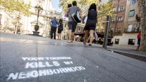 Pintadas contra el turismo y los pisos turisticos en la Placa de la Barceloneta    