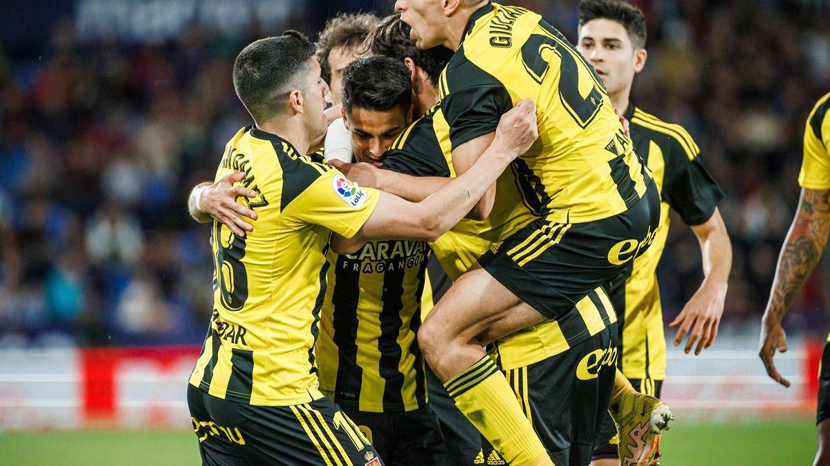 Los futbolistas del Real Zaragoza abrazan a Sergio Bermejo en la celebración del gol del empate ante el Levante.