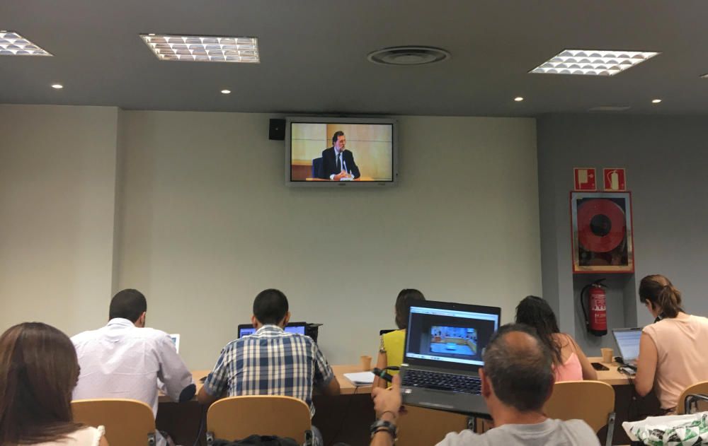 Spain's PM Rajoy is seen on a video screen of ...