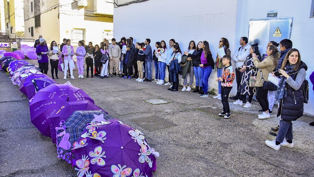 Los alumnos, junto a los paraguas violetas, durante la actividad.