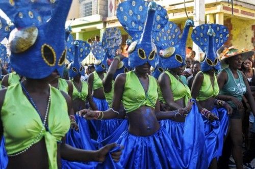 People, dressed as peacocks, take part in the Jacmel Carnaval