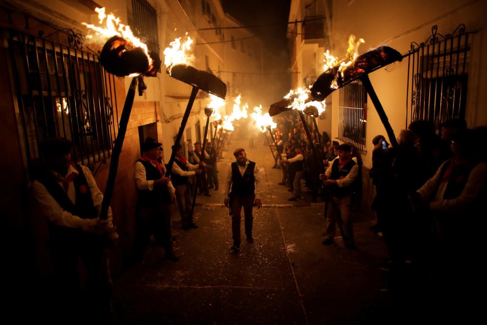 Villagers hold torches to represent light and ...