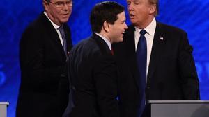 Republican presidential candidates Jeb Bush (L), Marco Rubio (C) and Donald Trump (R) greet one another following the Republican Presidential Candidates Debate on February 6, 2016 at St. Anselm’s College Institute of Politics in Manchester, New Hampshire.