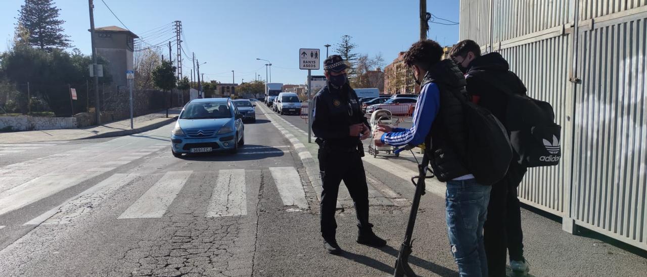 Un agente de la Policía Local informa a dos jóvenes en calles de Benicàssim.