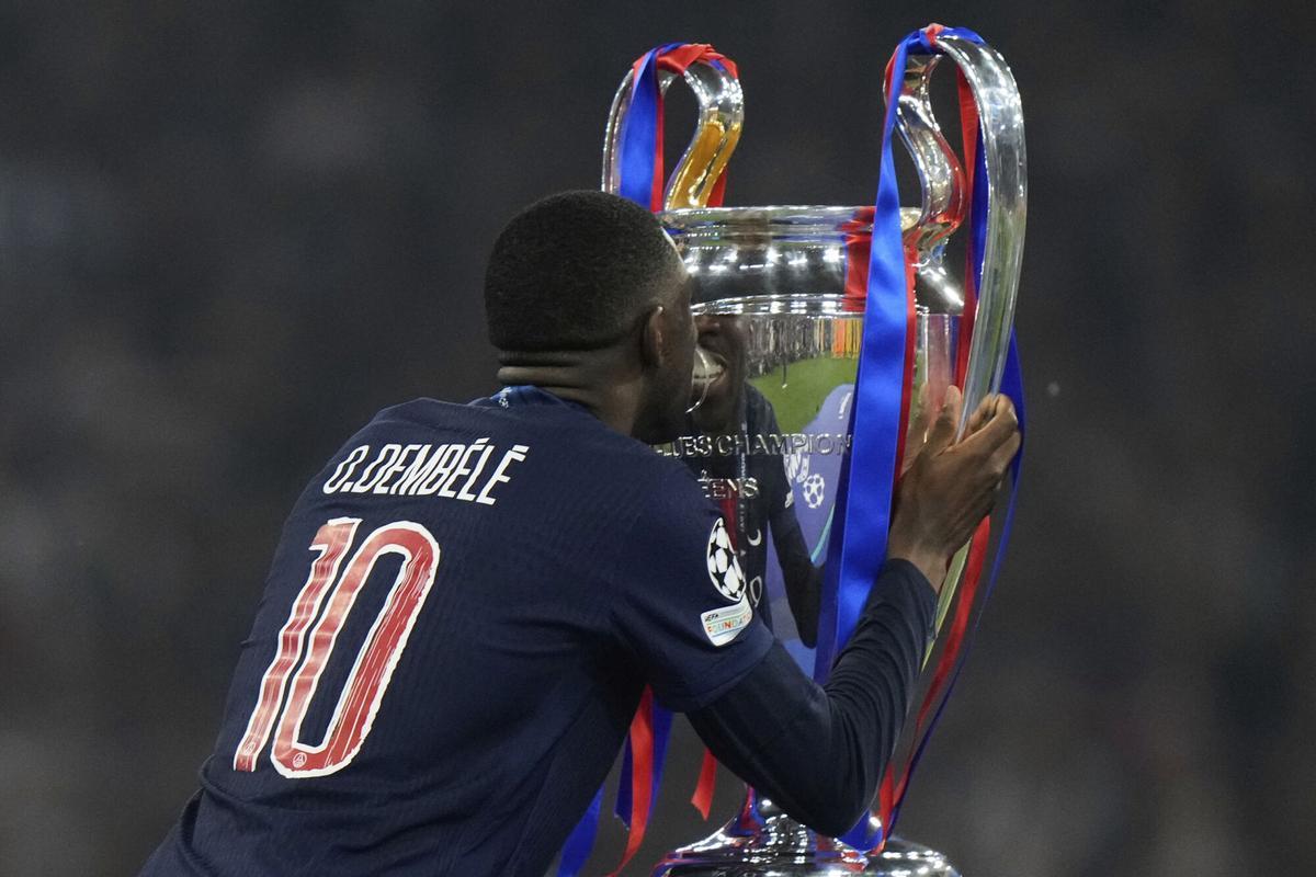 PSG's Ousmane Dembele kisses the trophy after winning the Champions League final soccer match between Paris Saint-Germain and Inter Milan at the Allianz Arena in Munich, Germany, Saturday, May 31, 2025. (AP Photo/Luca Bruno)