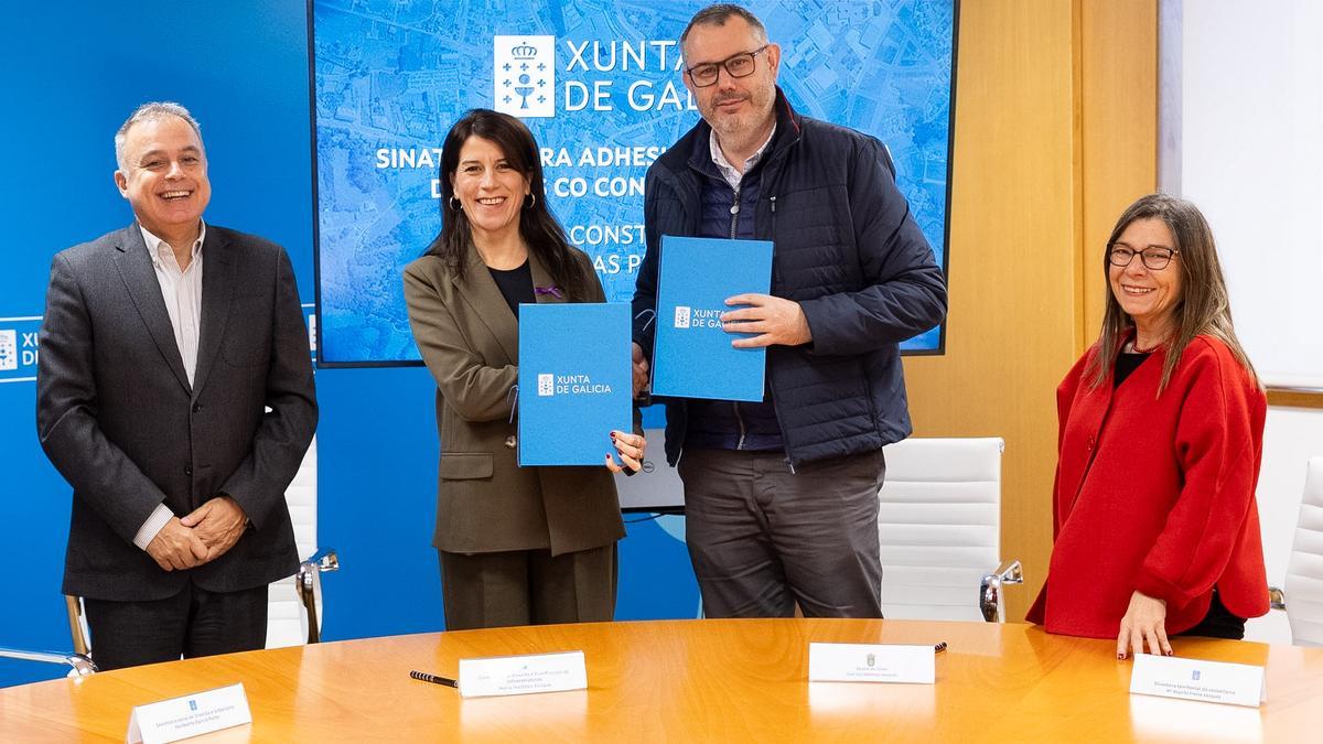 María M. Allegue y José Luis Martínez, ambos en el centro, tras firmar el convenio.