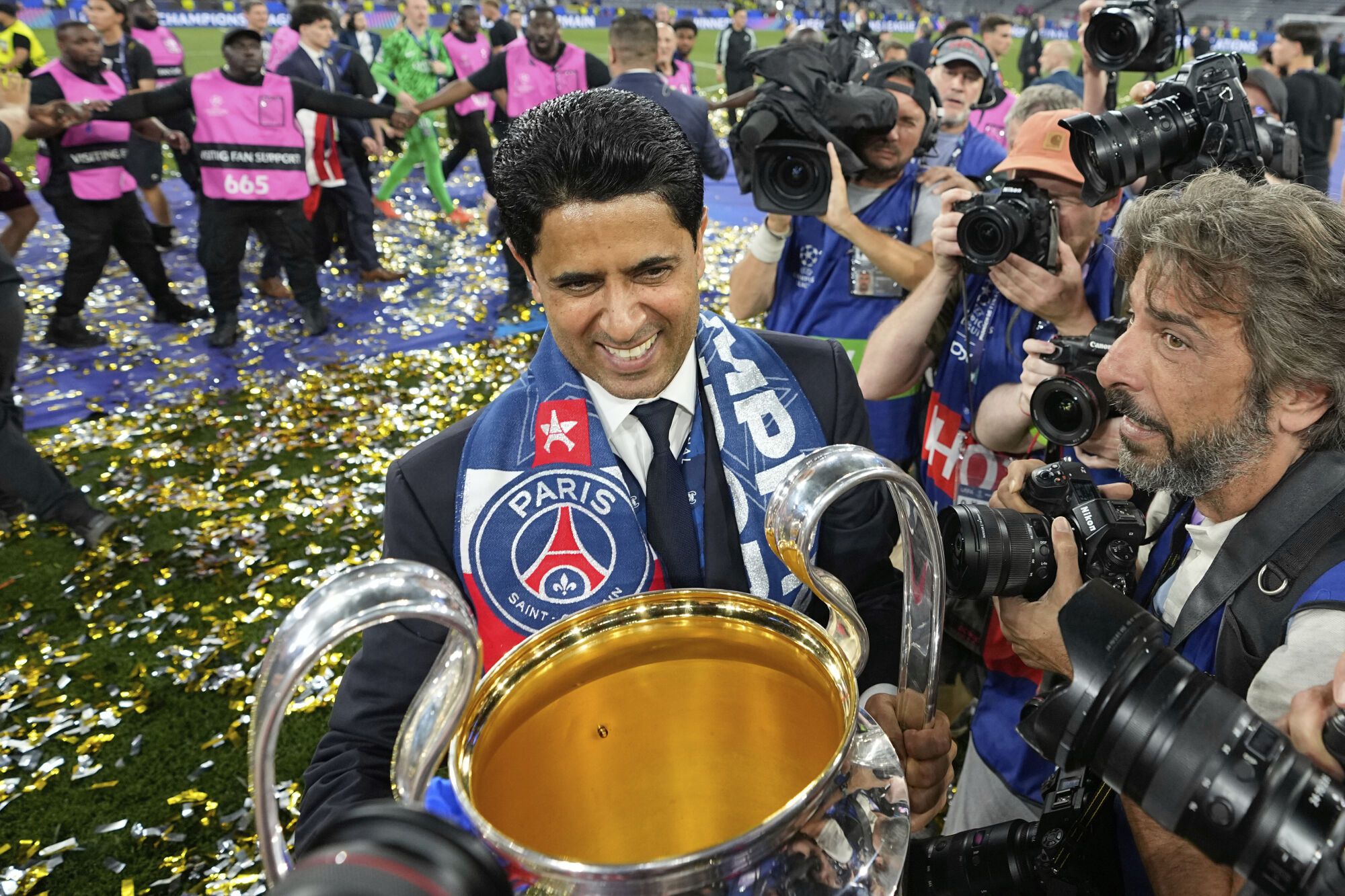 PSG president Nasser Al-Khelaifi holds the Champions League trophy after their win in the final soccer match against Inter Milan at the Allianz Arena in Munich, Germany, Saturday, May 31, 2025. (AP Photo/Martin Meissner)