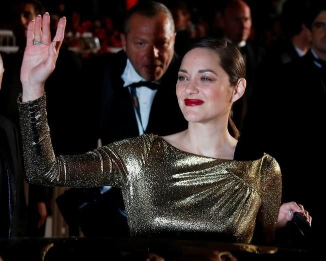 Cast member Marion Cotillard poses following the ...