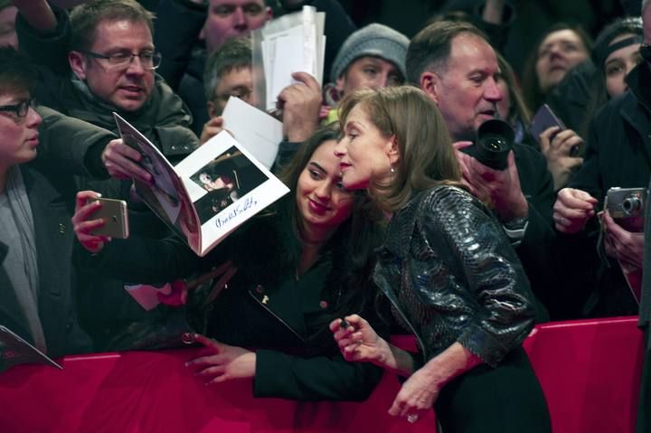 French actress Huppert signs autographes before the screening of the movie L'Avenir (Things to come) at the 66th Berlinale International Film Festival in Berlin