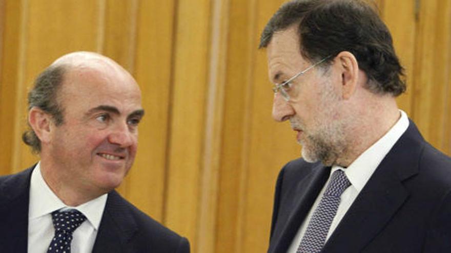 Guindos y Rajoy, en una anterior reunión.