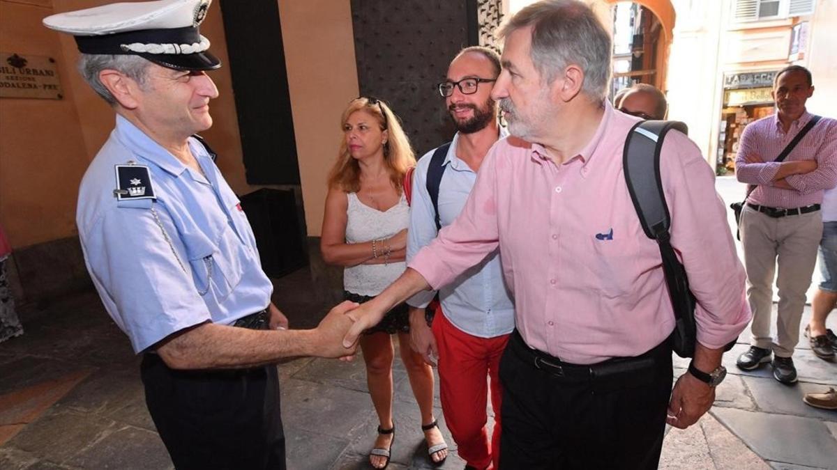 El nuevo alcalde de Génova, el conservador Marco Bucci (centro), saluda a un policía local a su llegada al Palazzo Tursi, sede de la alcaldía de Génova, el 26 de junio.