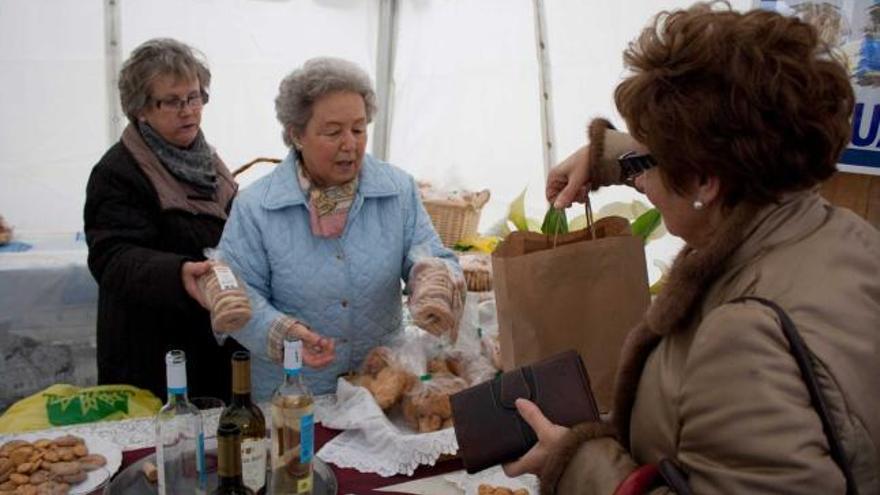 María Antonia Rosa y Visita Rodríguez venden una bolsa de marañuelas a María Fe Gutiérrez.