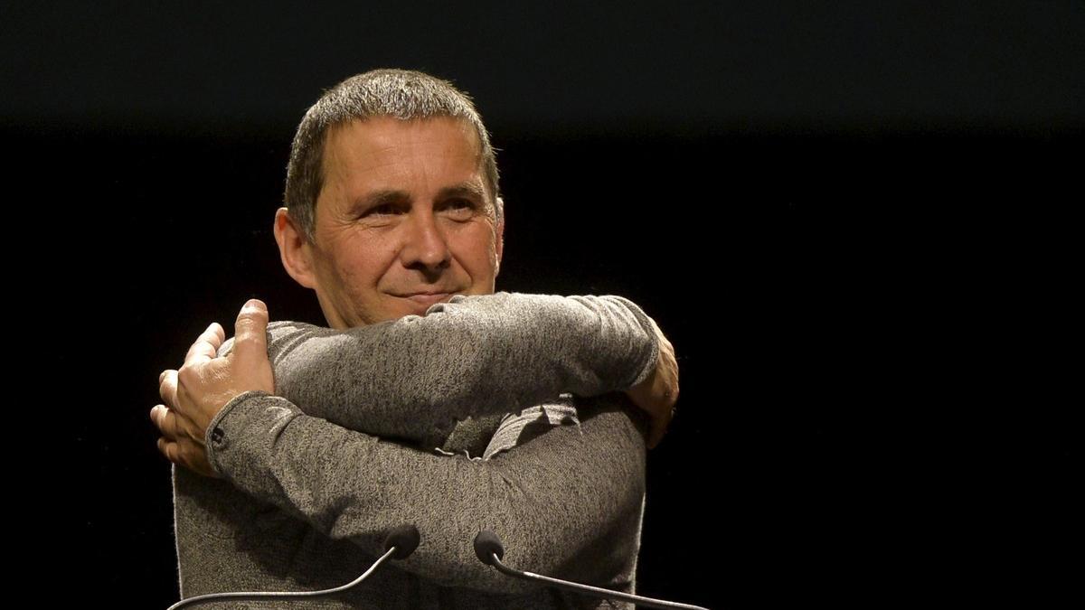 Basque pro-independence leader Arnaldo Otegi hugs himself during a meeting in San Sebastian