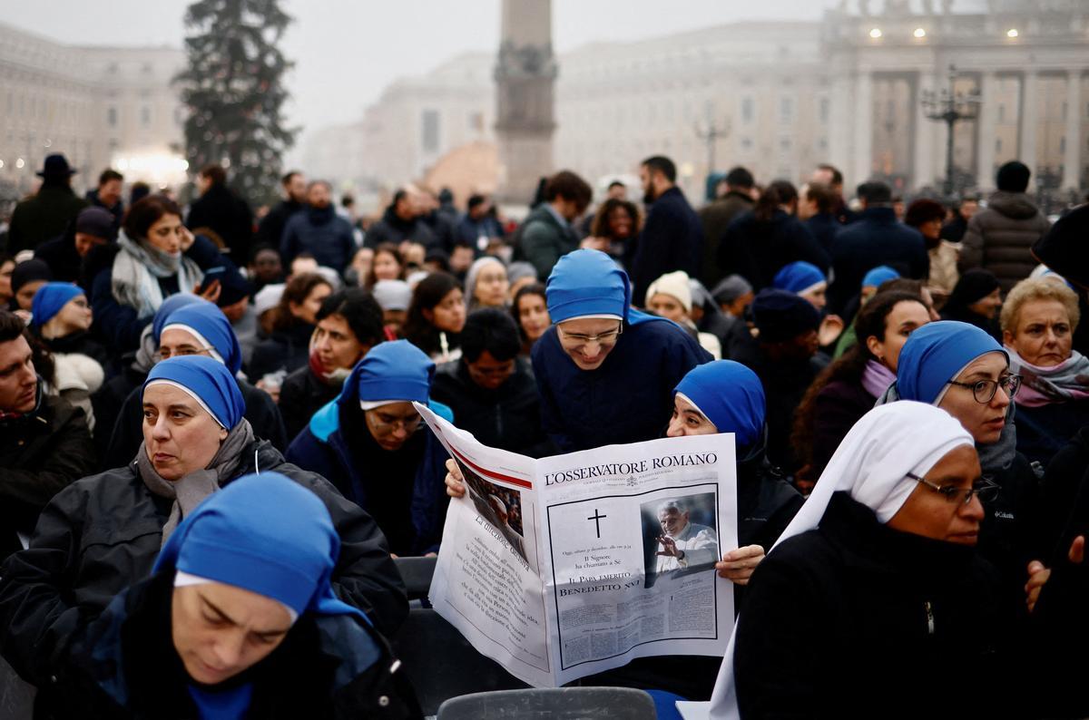 Monjas leen un periódico L’Osservatore Romano en la Plaza de San Pedro el día del funeral del ex Papa Benedicto en el Vaticano.