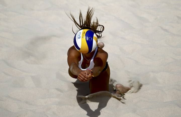 Graudina of Latvia dives for the ball during their preliminary beachvolleyball match against Czech Republic at the 1st European Games in Baku