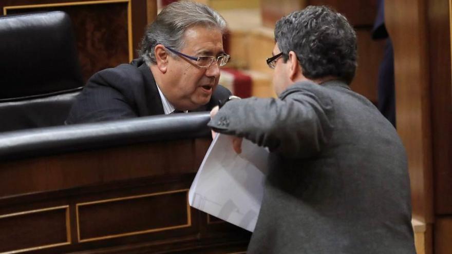 El ministro del Interior, Juan Ignacio Zoido, sentado, conversa con el de Energía, Álvaro Nadal, en el Congreso.