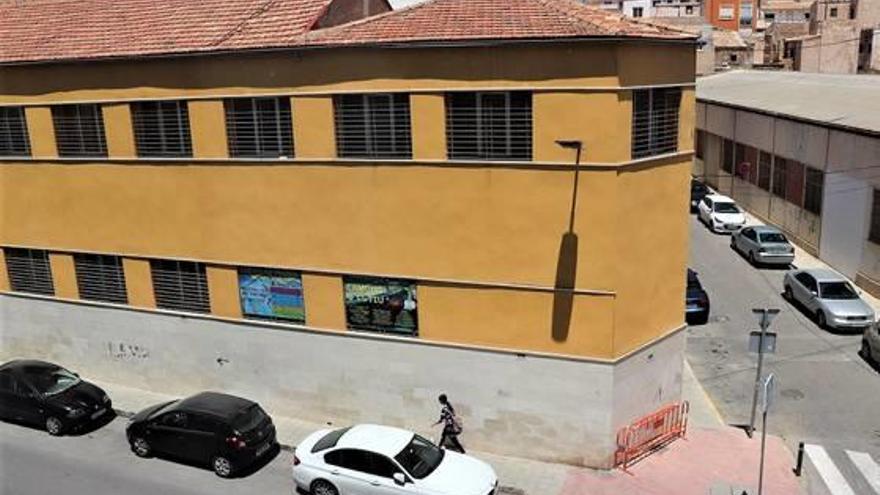 Fachada del gimnasio municipal de Crevillent con grietas en la parte superior del edificio.