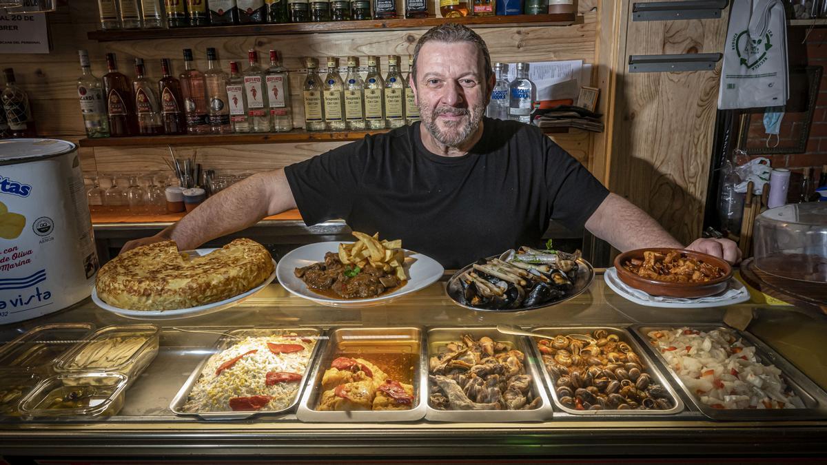 Javier Caballero, al frente del Bar Bodega Gol, muestra algunos de sus platos estrella:  surtido de 'closques', fricandó de carrillera y 'cap i pota'.