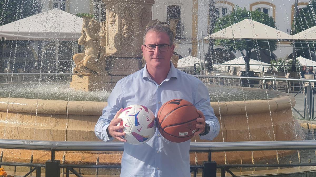 Constantino Manuel Rubio posa con dos balones (fúbol y baloncesto), en la plaza España.