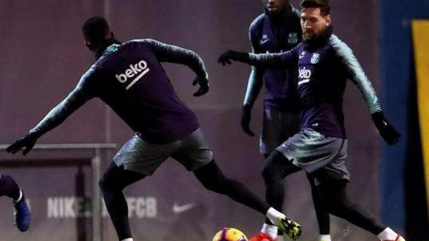 Leo Messi i Nélson Semedo pugnen per una pilota en presència de Dembélé, en l&#039;entrenament d&#039;ahir