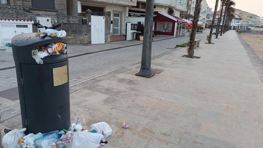 La basura rebosa una papelera en el paseo de Panxón.