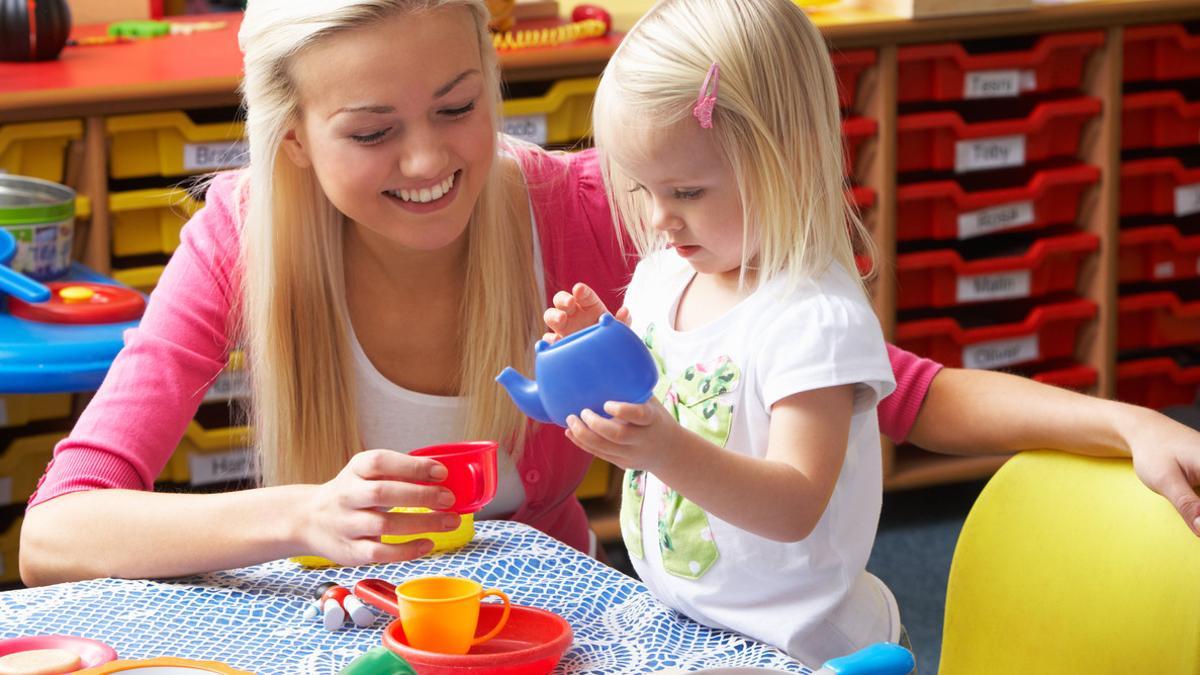 Young woman playing with girl