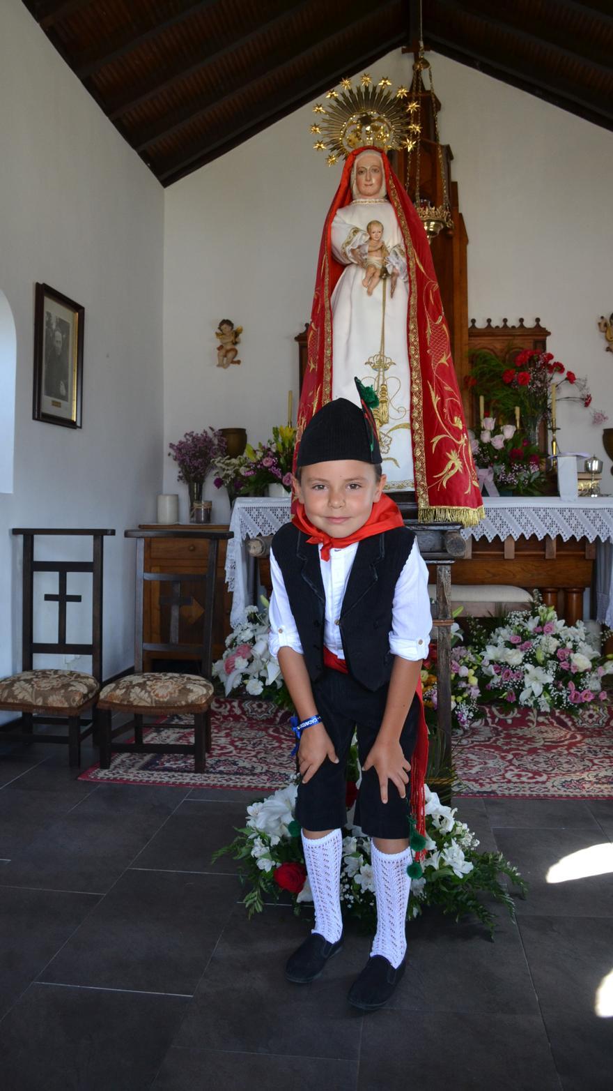 El niño Nicolás Fernández de la Uz, de siete años, posa ante la Virgen de Reigla.