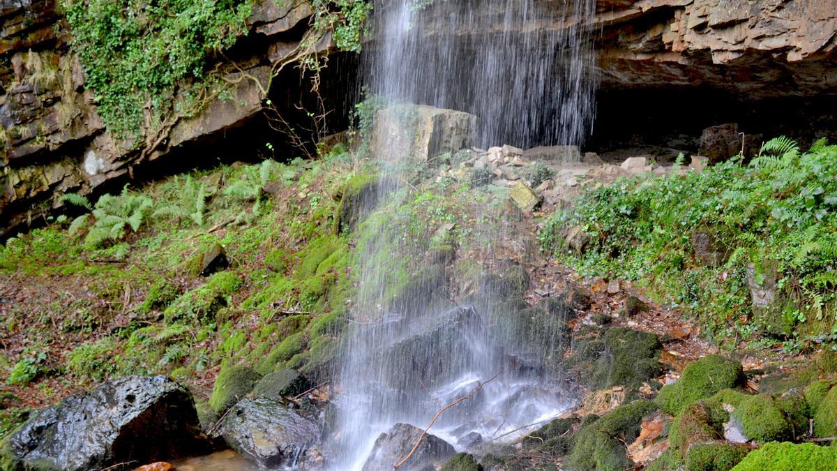 El agua cae en el exterior de la cueva del Pímpano, en Villayón.