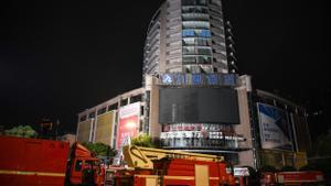 ZIGONG, July 18, 2024  -- This photo taken on July 18, 2024 shows firefighting vehicles at the site of a department store fire in Zigong City, southwest Chinas Sichuan Province. The rescue operation at the site of the department store fire in Zigong City