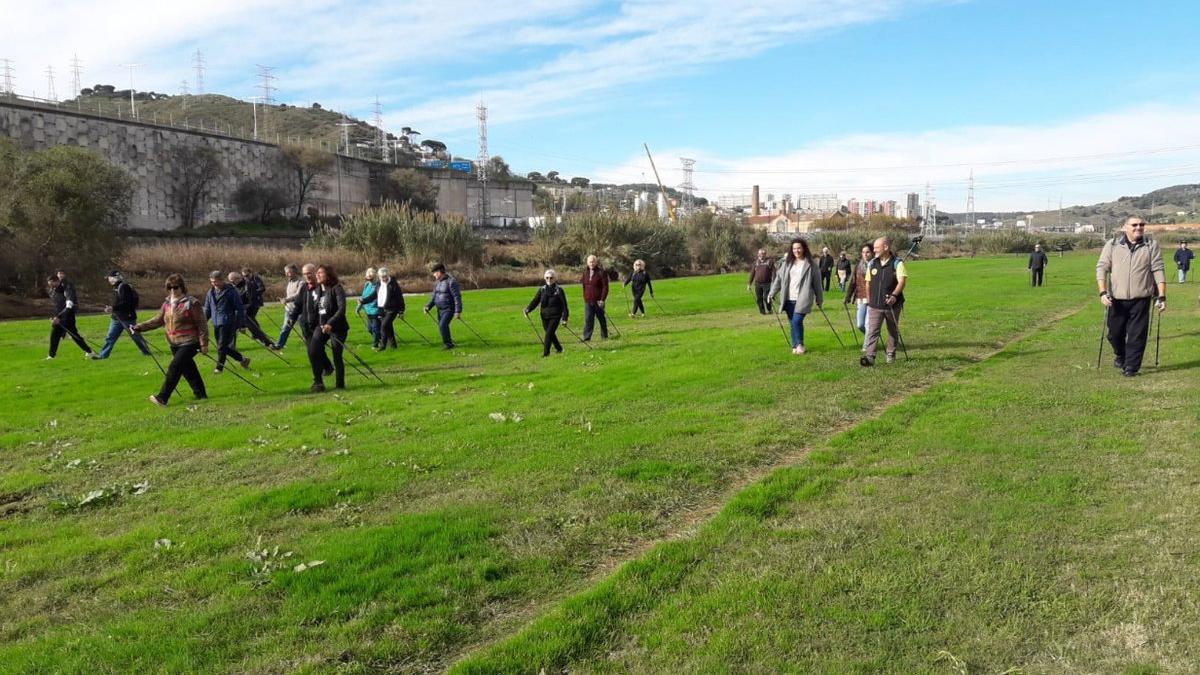 Miembros de la Asociación Aire practican marcha nórdica por el parque fluvial del Besòs